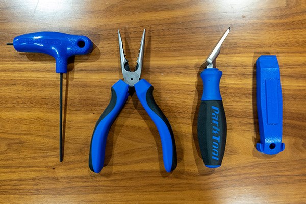 2.5mm allen key needle nose pliers brake pad spreader and tyre levers all from park tools